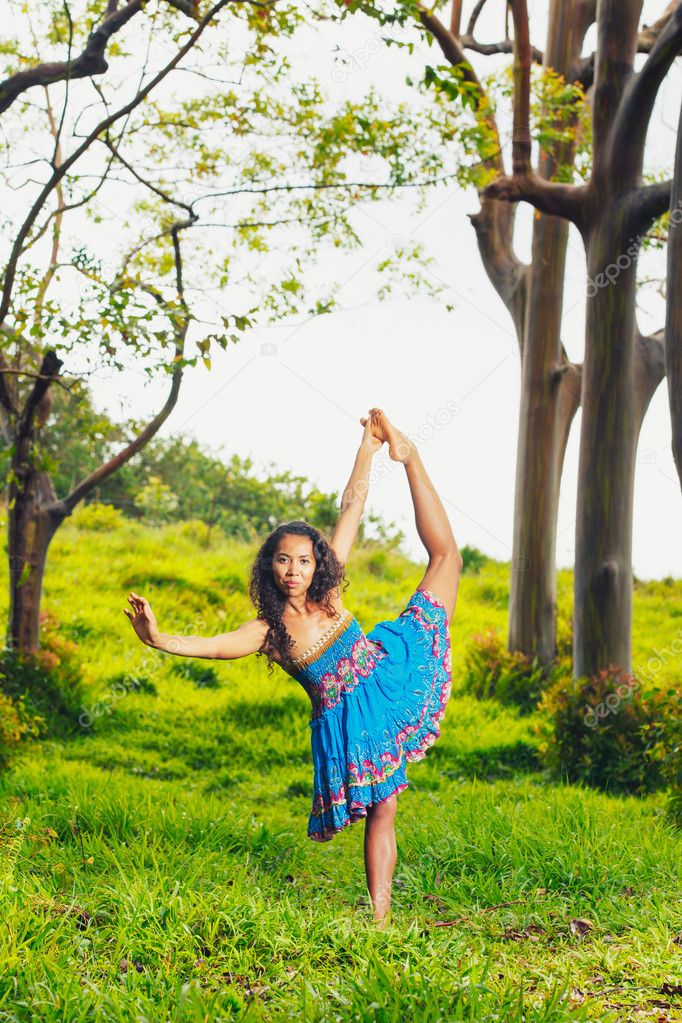 Beautiful Woman Practicing Yoga Outside in Nature
