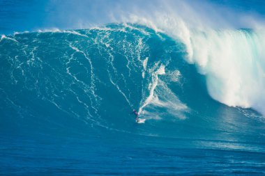 MAUI, HI - MARCH 13: Professional surfer Archie Kalepa rides a g clipart