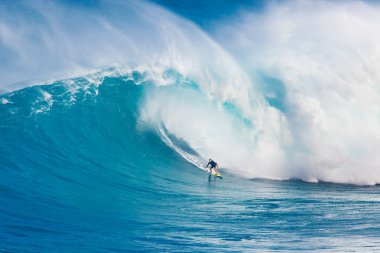 MAUI, HI - MARCH 13: Professional surfer Carlos Burle rides a gi clipart