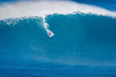 MAUI, HI - MARCH 13: Professional surfer Michel Larronde rides a clipart