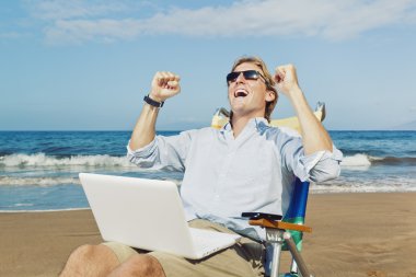 Young Attractive Man Celebrating Success, Working on Computer at clipart