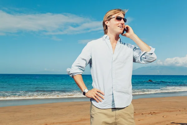 Business man calling by cell phone on the beach Stock Image