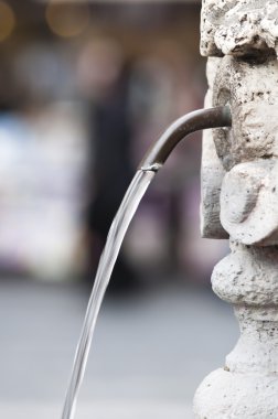 A fountain of free drinkable water in Rome clipart