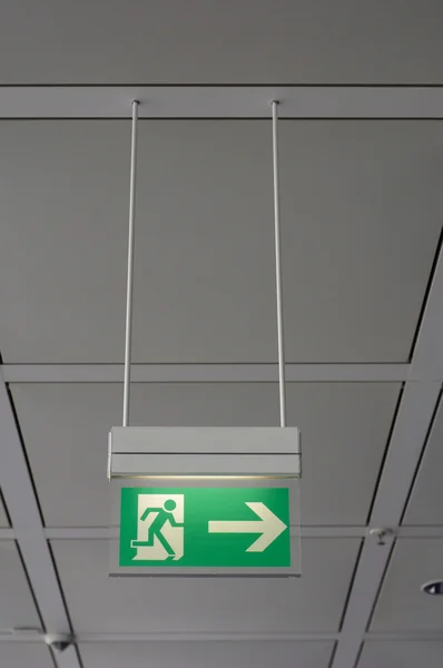 stock image Direction sign for emergency exit out a building