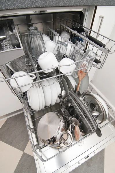 Dish washer with clean and shiny dishes and kitchenware — Stock Photo, Image
