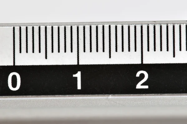 Metallic ruler in centimeters with white numbers and black markings — Stock Photo, Image