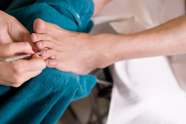 stock image Man and the procedure of pedicure