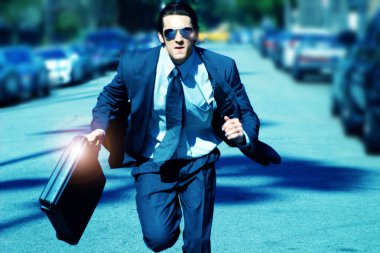 Young man running with briefcase clipart