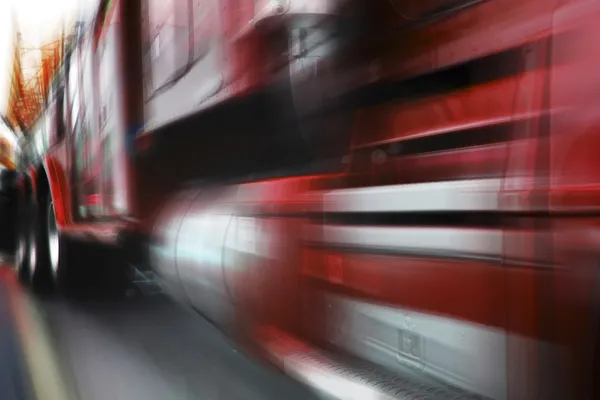 stock image Photo of moving red truck