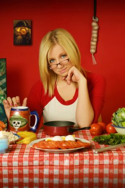 Blond girl sitting at table clipart