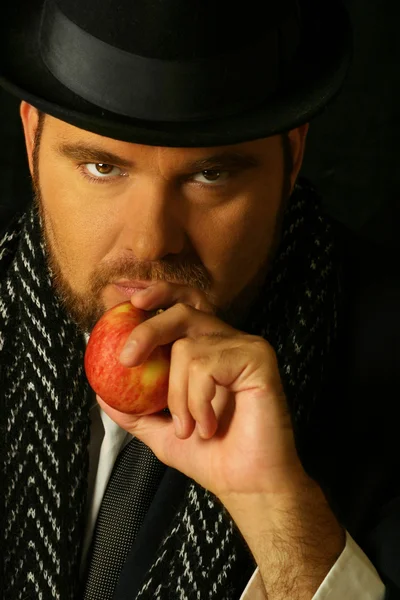 Sinister man with apple — Stock Photo, Image
