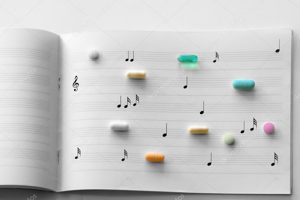 Prescription pills on music paper