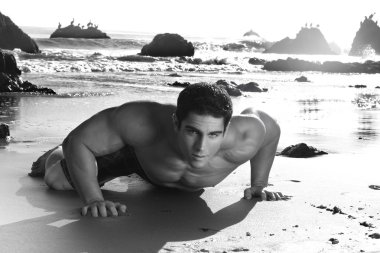 Sexy man on beach clipart