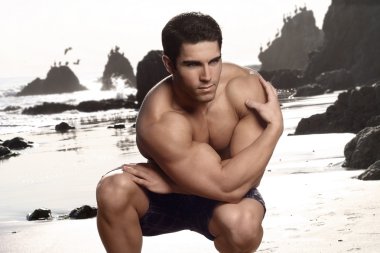 Bodybuilder at beach clipart