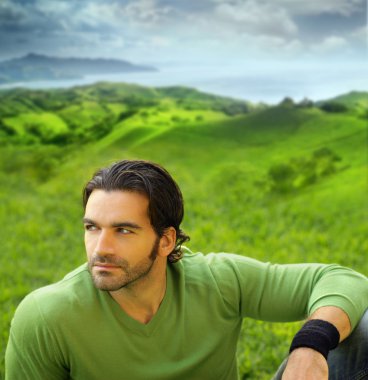 Portrait of a relaxed good-lookiing young man in natural setting clipart