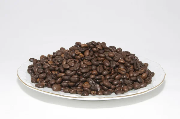 Placa con granos de café — Foto de Stock