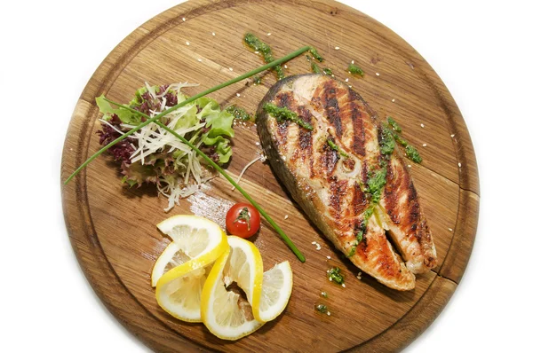 Wooden plate with a piece of fish — Stock Photo, Image