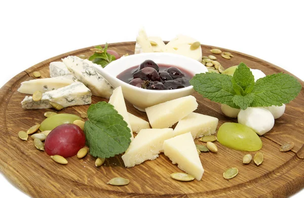 Cheese on a wooden plate — Stock Photo, Image