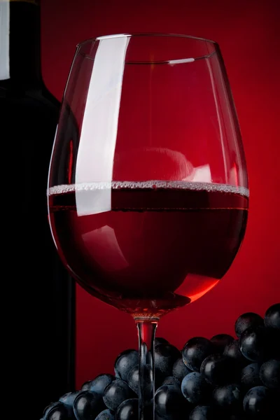 A glass full of wine and bottle — Stock Photo, Image