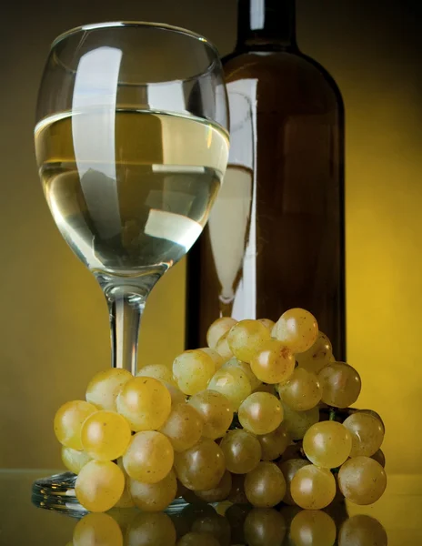 Una copa de vino, botella y uvas — Foto de Stock
