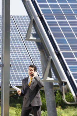 Businessman and solar panels clipart