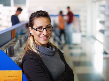 Portrait of salesgirl in cd store clipart