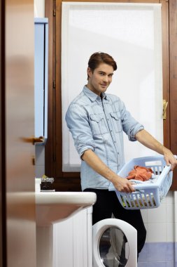 Man doing chores with washing machine clipart