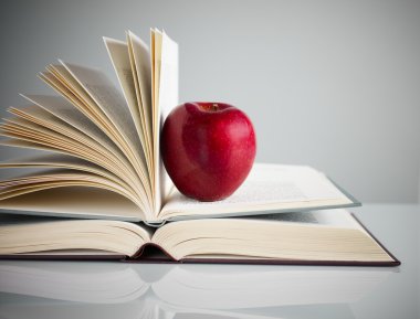 Red apple on books clipart