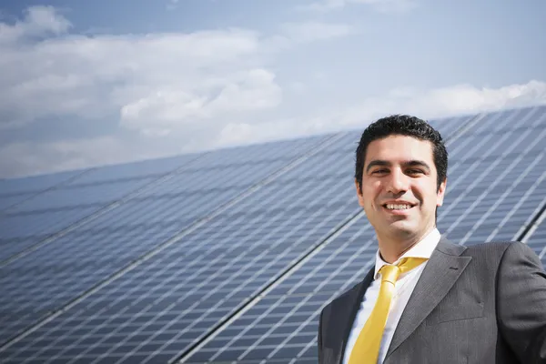 Businessman and solar panels — Stock Photo, Image