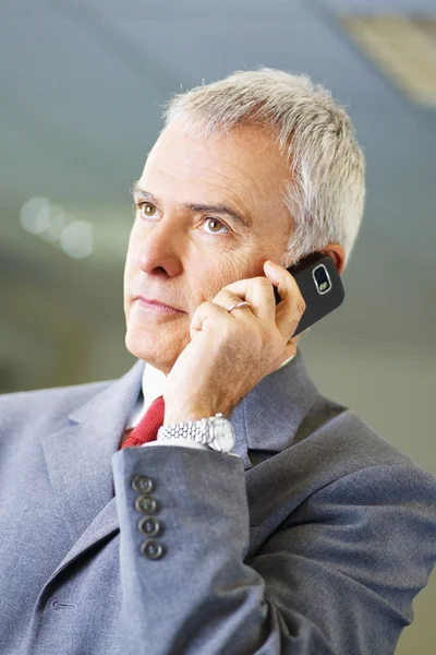 Homme d'affaires mature au téléphone au bureau — Photo