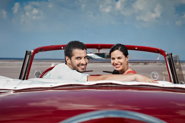 Man and beautiful woman hugging in cabriolet car — Stock Photo, Image
