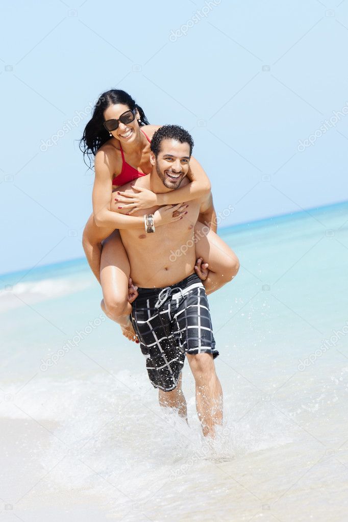Piggyback ride with happy man and woman