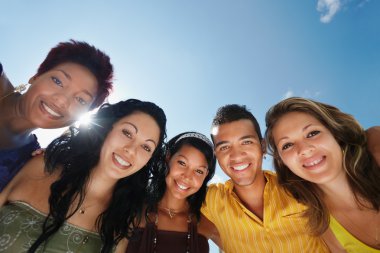 Team of man and women embracing, smiling at camera clipart