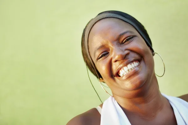 Black woman with white shirt smiling at camera — Stock Photo, Image