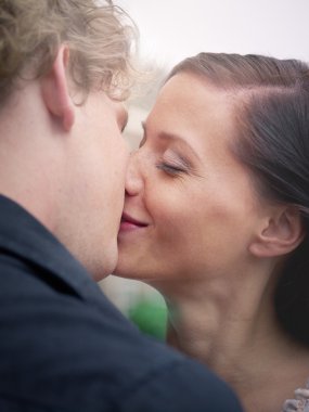 Man and woman kissing and smiling clipart