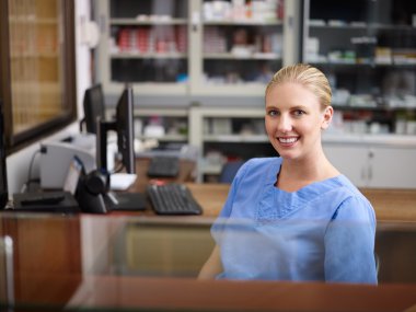 Woman working as nurse at reception desk in clinic clipart