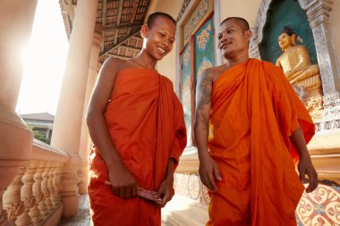 Two monks meet and salute in a buddhist monastery, Asia clipart
