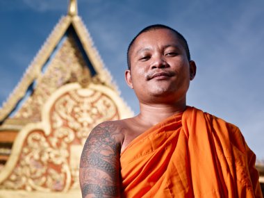 Portrati of buddhist monk near temple, Cambodia, Asia clipart