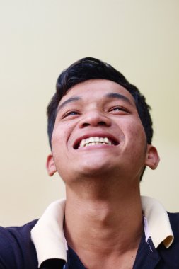 Eyes of happy young asian man looking at camera clipart