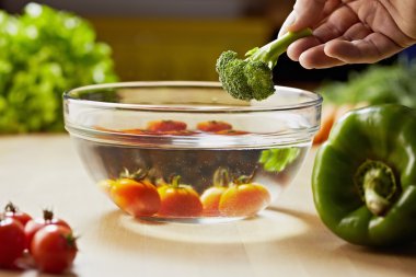 Tomatoes, broccoli and vegetables on kitchen table clipart