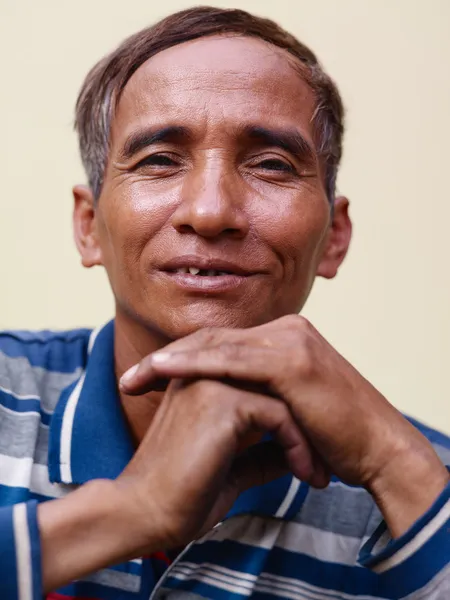 Mature Asian man smiling and looking at camera — Zdjęcie stockowe