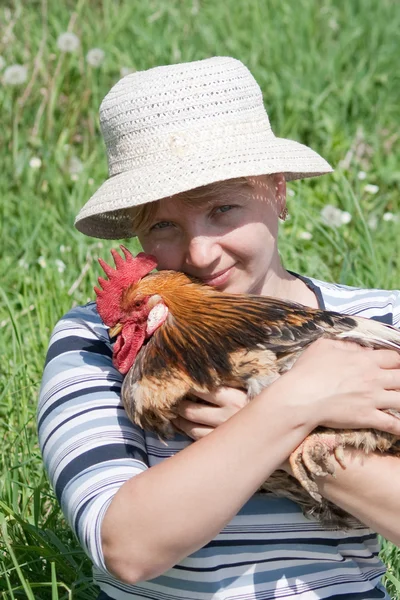 Rooster and woman — Stock Photo, Image