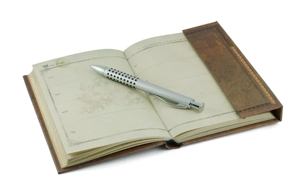 Um velho caderno e caneta prata — Fotografia de Stock