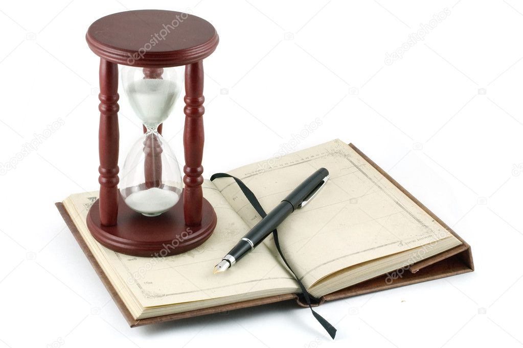 Hourglass, fountain pen and a notebook