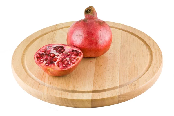 Juicy pomegranate on the kitchen cutting board — Stock Photo, Image