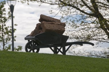 Wheelbarrow with peat clipart