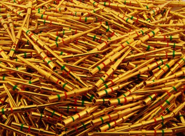 Golden plated electrical pins. Background clipart
