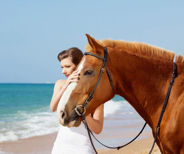 stock image Girl with horse on the beach