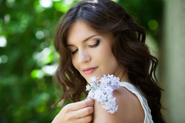 Girl with lilac flower — Stock Photo, Image