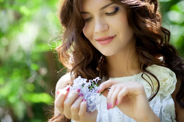 Girl with lilac flower — Stock Photo, Image